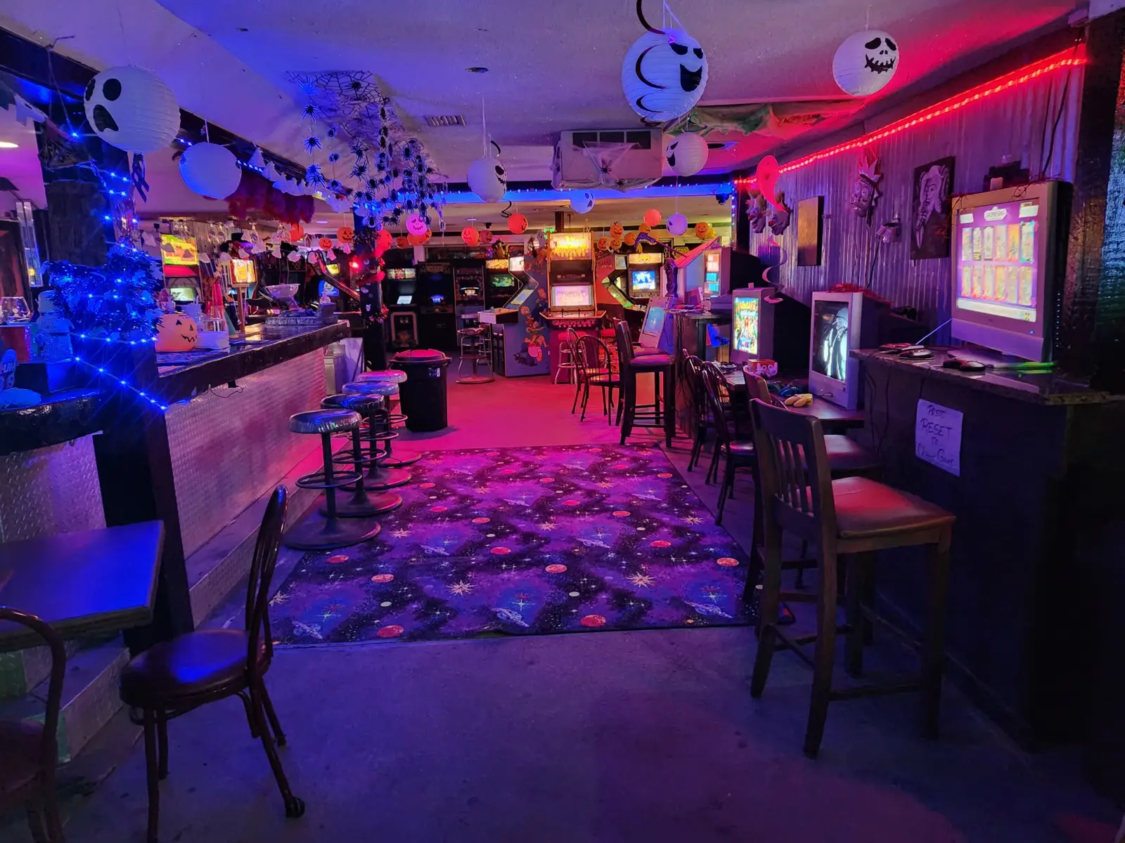 The bar and console stations with stools and a space-themed carpet