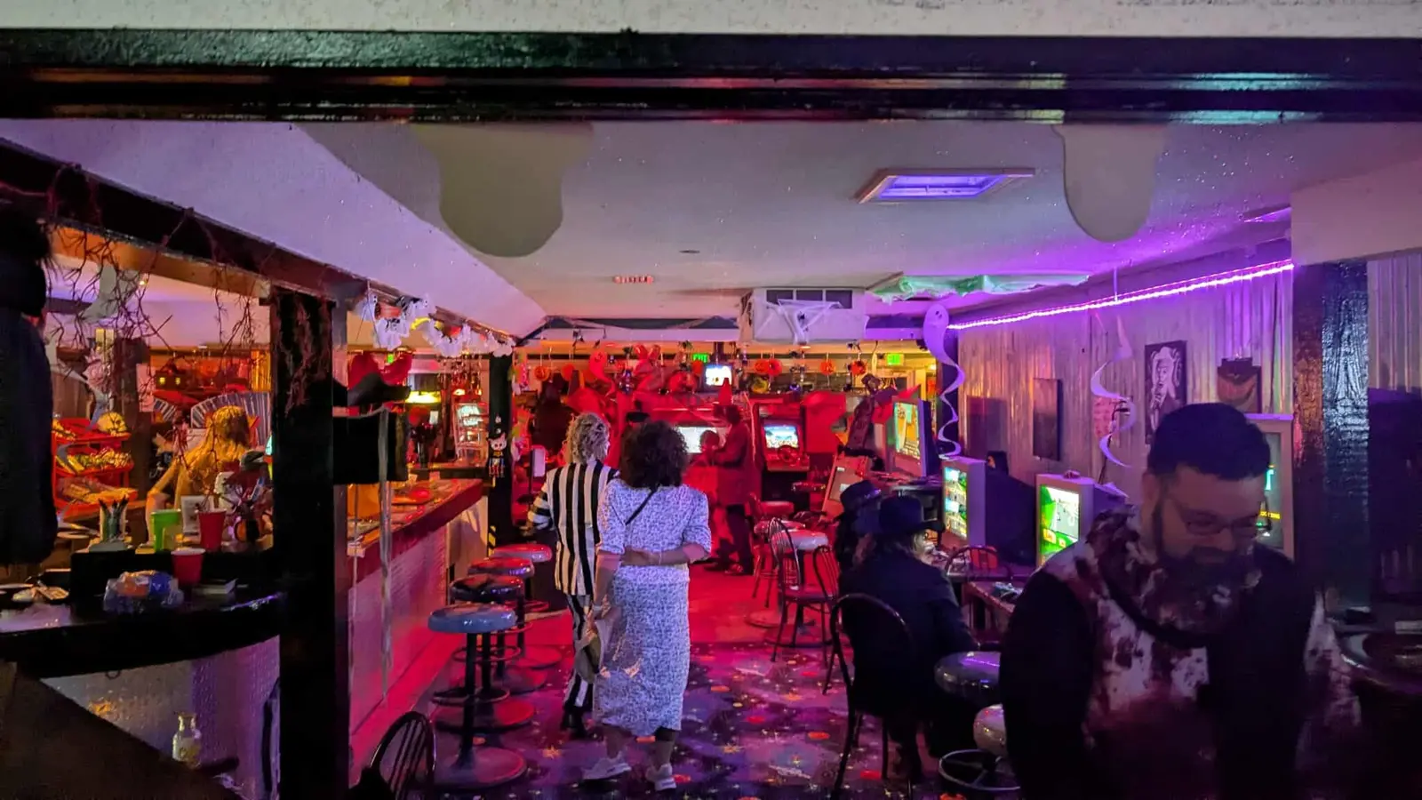 Guests in costume walking past the bar