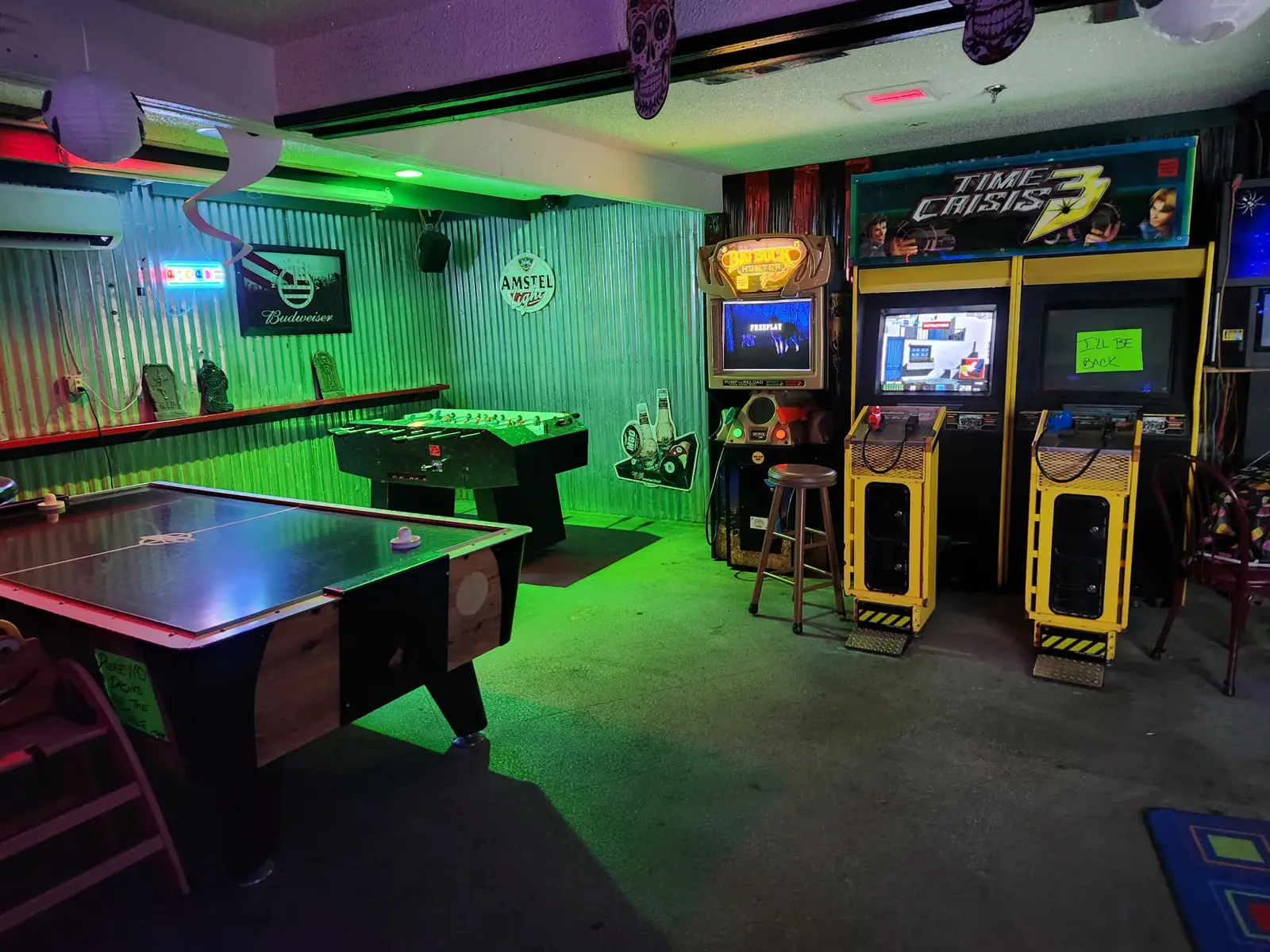 Game room with air hockey, foosball, Big Buck Hunter Pro and Time Crisis 3